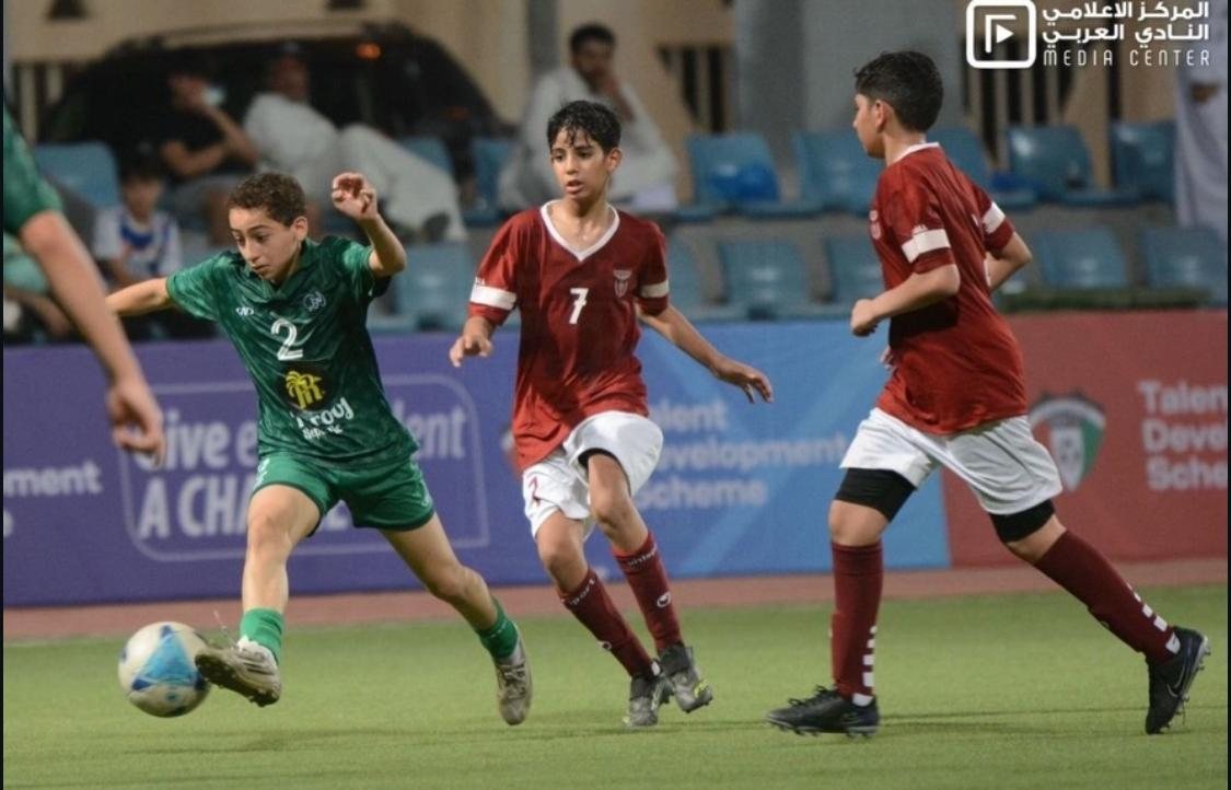 Al Arabi SC youth player on the ball